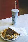 A Garbage Plate served at Nick Tahou's with Pepsi and Italian bread